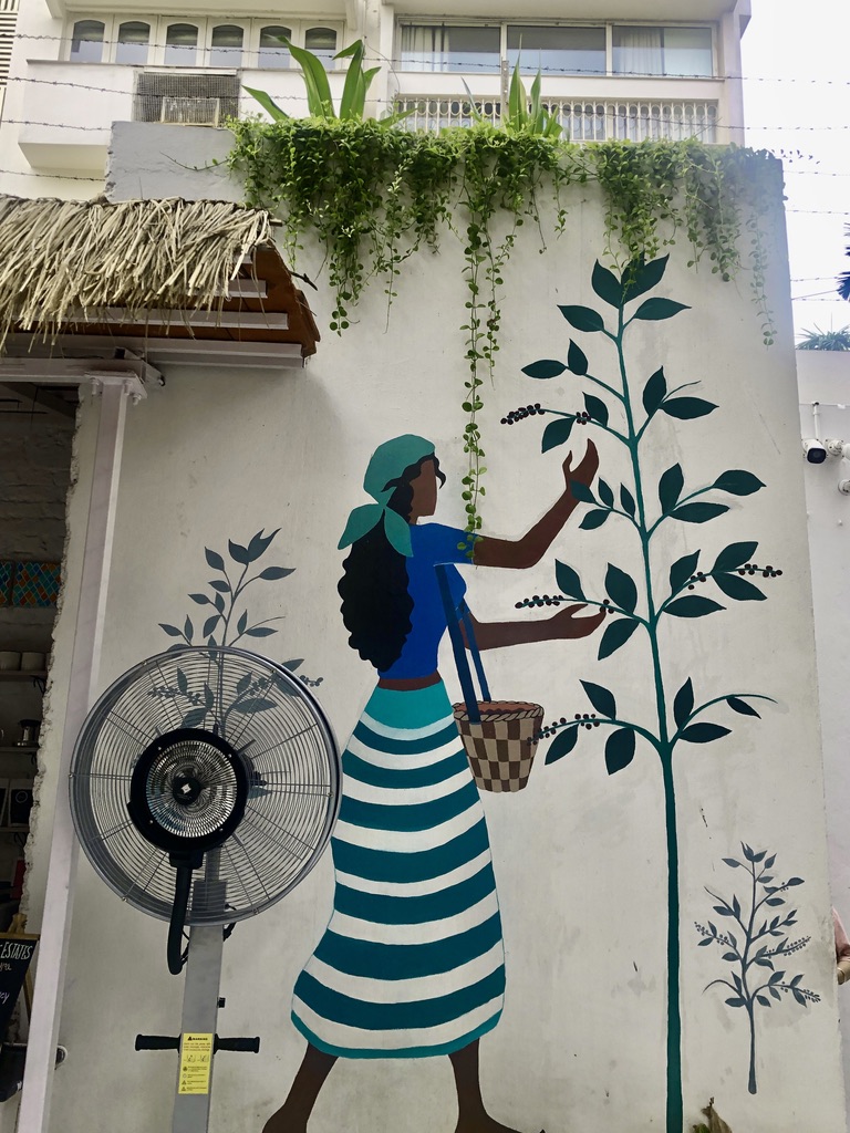A wall mural of a girl touching the green leaves for poem because my thoughts are hands 