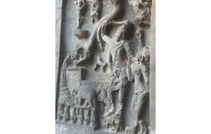 Ellora Cave- stone carvings of human figurine on walls